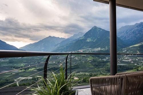 a balcony with a view of a valley and mountains at Prunner Luxury Suites - Adults Only in Schenna
