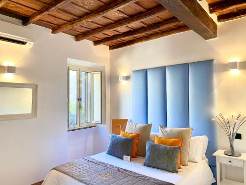 a bedroom with a bed with a blue accent wall at Palace Fontana di trevi Apartments in Rome