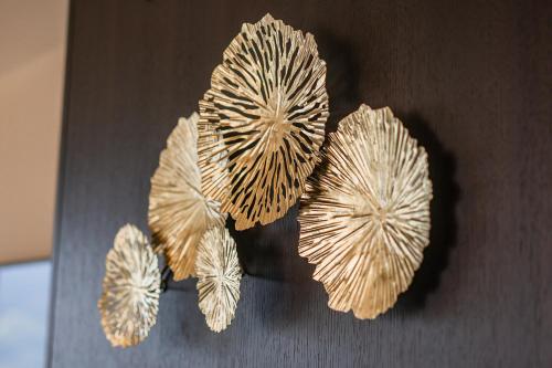 a group of four dried flowers on a table at Prunner Luxury Suites - Adults Only in Schenna