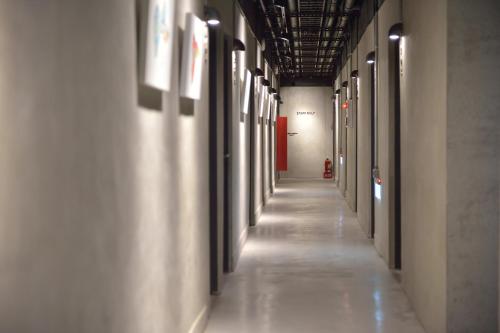 an empty hallway in a building with white walls at Home Rest Hotel 2 in Taitung City