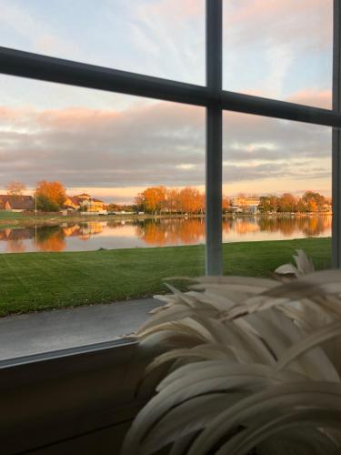 a view of a lake from a bedroom window at Viigi Villa in Haapsalu