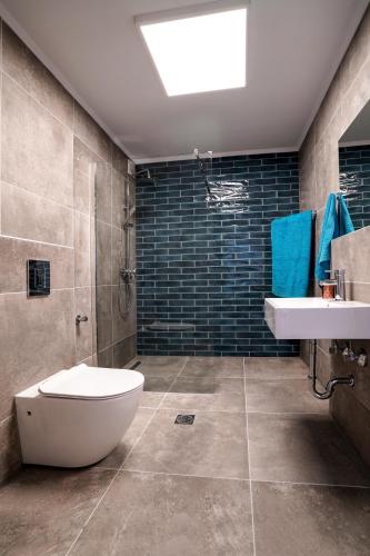 a bathroom with a toilet and a sink at Dimitra Beach Apartments - Nea Karvali Kavala in Néa Karváli