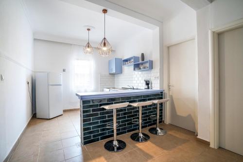 a kitchen with a blue counter and a refrigerator at Dimitra Beach Apartments - Nea Karvali Kavala in Néa Karváli