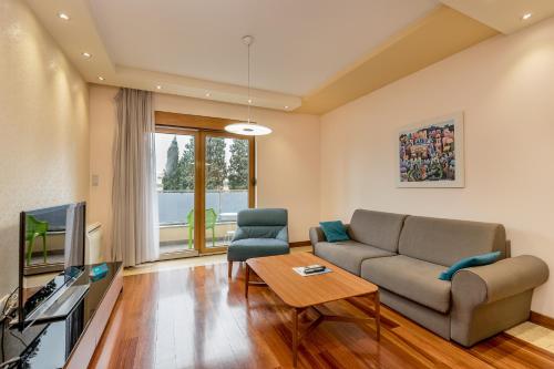 a living room with a couch and a tv at Apartments Athos in Podgorica