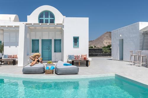a doll sitting on a raft next to a swimming pool at Santa Irina Luxury Sunny Lofts in Perivolos
