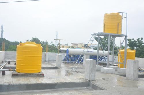 a group of yellow cylinders sitting on top of a building at Hotel Aishwariyam in Tirukkadaiyūr