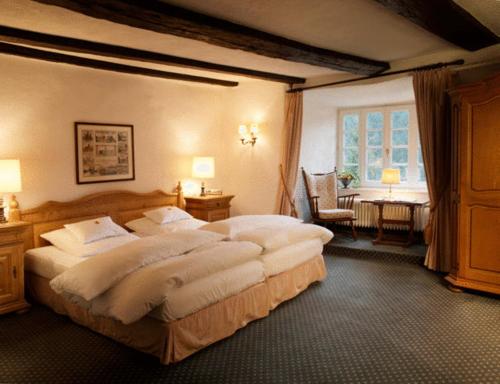 ein großes Schlafzimmer mit einem großen Bett in einem Zimmer in der Unterkunft Hotel und Restaurant Burg Schnellenberg in Attendorn