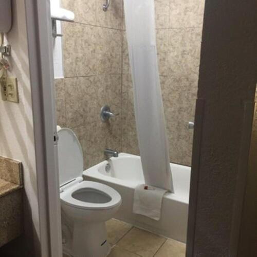 a bathroom with a toilet and a sink and a shower at Baymont by Wyndham Walterboro in Walterboro