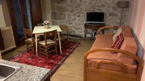 a living room with a couch and a table at Aptos La Ceja, El Trampal y El Reloj by CASA BOLDO in Candelario