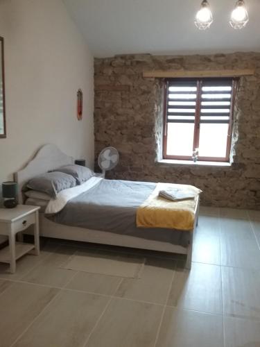 a bedroom with a bed and a window at Lake view in Cieux