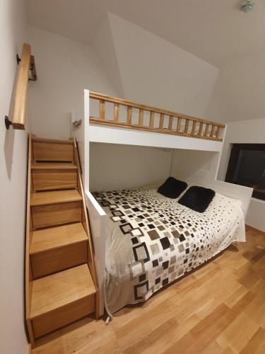 a bedroom with a bunk bed and a staircase at Vila Irina Kopaonik - Apartman IN in Kopaonik