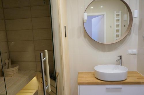 a bathroom with a sink and a mirror at Enklawa Białowieska Forest & Spa in Hajnówka