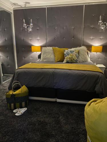 a bedroom with a large bed with a purple headboard at Peacock Cottage, 95 Eden Wilds in Port Edward