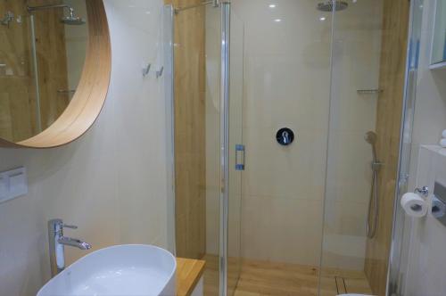 a bathroom with a shower with a toilet and a sink at Enklawa Białowieska Forest & Spa in Hajnówka