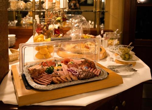 a table with a plate of food on a table at Akzent Hotel Am Goldenen Strauss in Görlitz