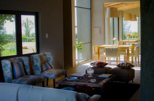 a living room with a couch and chairs and a table at Casa de Huéspedes La Azul in Los Árboles