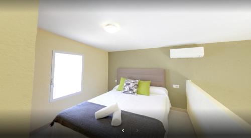 Dormitorio pequeño con cama y ventana en Alojamiento Café Soles, en Denia