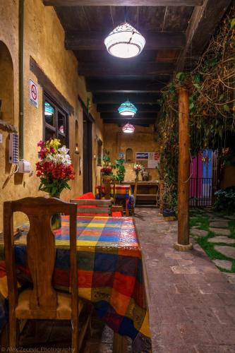 a room with a table with a colorful rug on it at Posada del Abuelito (Hostel) in San Cristóbal de Las Casas