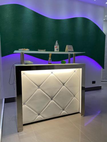 a green wall with a table on top of a desk at B&B Rossini Luxury 2 in Cosenza