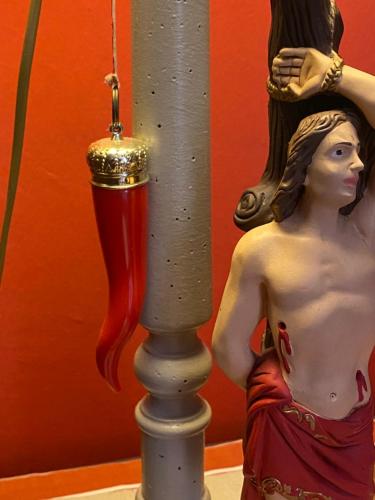 a statue of a woman standing next to a pole at B&B Binot in Carmagnola