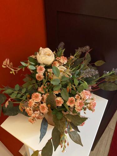 a bouquet of flowers in a vase on a table at B&B Binot in Carmagnola