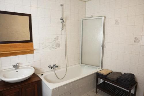 a bathroom with a tub and a sink and a shower at Alte Mühle Kelbra - ehemalig ALBIG in Kelbra
