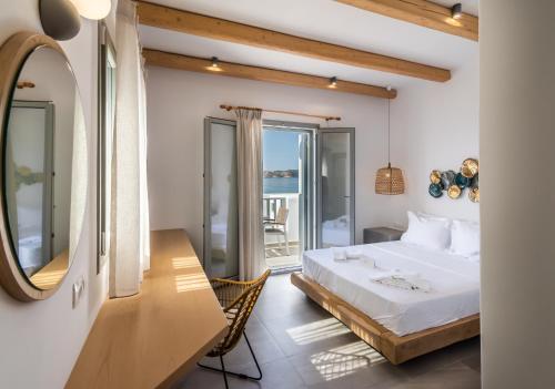 a hotel room with a bed and a mirror at Olea Bay Hotel in Adamantas