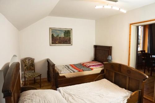 a bedroom with two beds and a chair at Alte Mühle Kelbra - ehemalig ALBIG in Kelbra