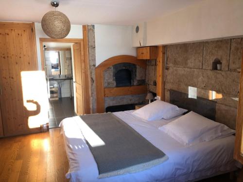 a bedroom with a large bed with a wooden headboard at Golf du Rochat in Les Rousses