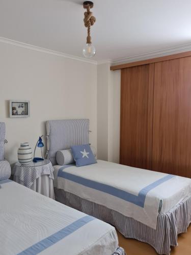 Ένα ή περισσότερα κρεβάτια σε δωμάτιο στο Pé na Praia da Foz