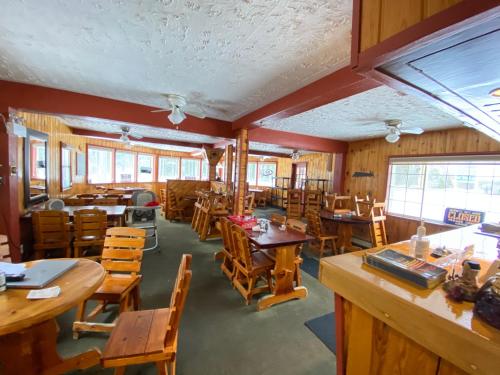 een eetkamer met houten tafels en stoelen bij Rolphton Motel and Restaurant 