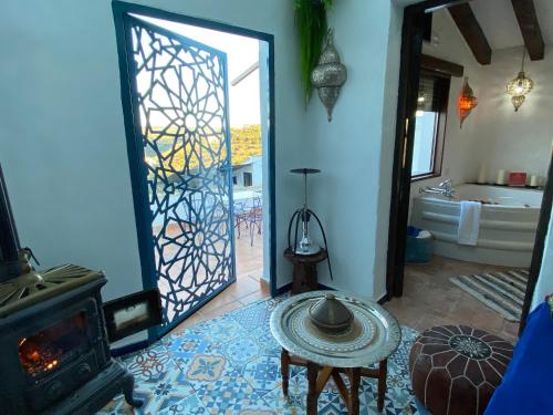 a living room with a door open to a bathroom at El Escondite de Martina, Áticos Románticos in Setenil