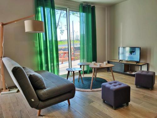 a living room with a couch and a tv at Le Cottage Nature Primeur Sauna Gaillac entre Albi-Toulouse & Les Cottages du Tarn in Brens