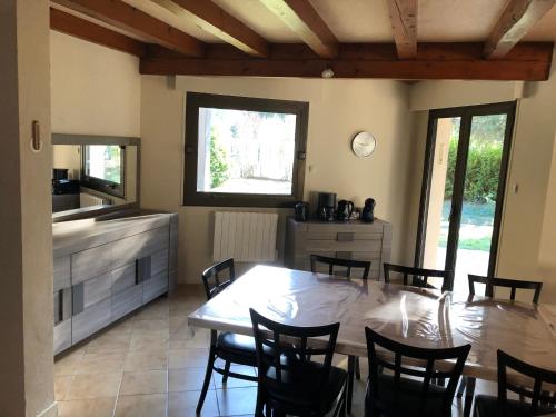 a kitchen and dining room with a table and chairs at LUCHON Chalet 16 Couchage in Montauban-de-Luchon