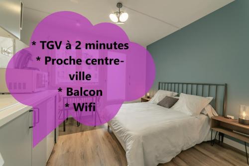 a bedroom with a large bed with a purple heart at apparthotel-gare-chambery in Chambéry