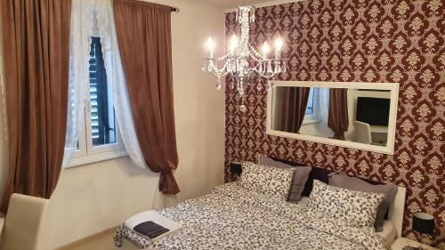 a bedroom with a bed and a mirror at Apartments Paris in Umag