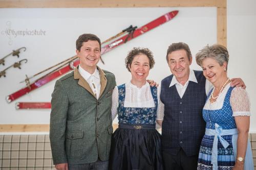 a group of four people posing for a picture at Boutique Hotel Eggele in San Candido