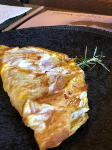 a piece of food sitting on a black plate at Canto do Irere - Boutique Hotel in Atibaia