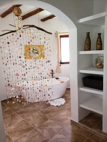 a bathroom with a white tub and a sink at Casa Hridaya Hotel Boutique in Holbox Island