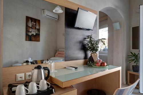 a kitchen with a counter with a sink and a mirror at Hotel Rex in Kalabaka