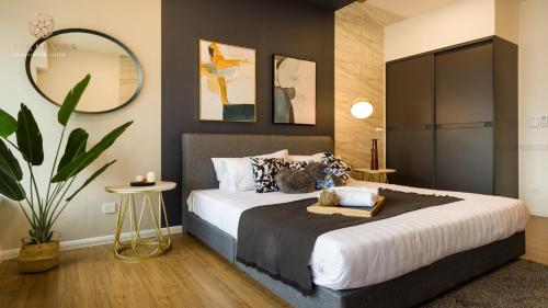 a bedroom with a large bed and a mirror at Ceylonz Suite Kuala Lumpur Five Senses in Kuala Lumpur