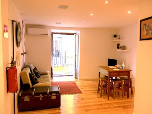 a living room with a table and a dining room at Cozy Studio in Mouraria with AC in Lisbon