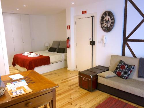 a living room with a couch and a bed at Cozy Studio in Mouraria with AC in Lisbon