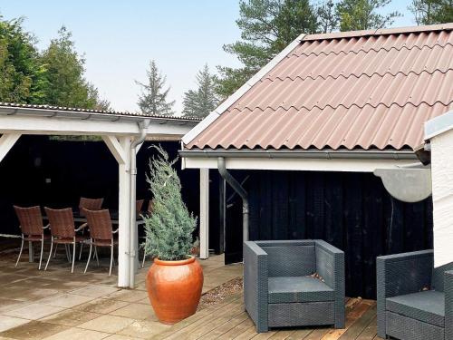 a patio with a pot with a plant in it at 6 person holiday home in Brovst in Brovst
