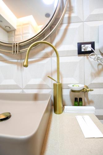a bathroom with a sink and a mirror at Vila EKREM in Korçë