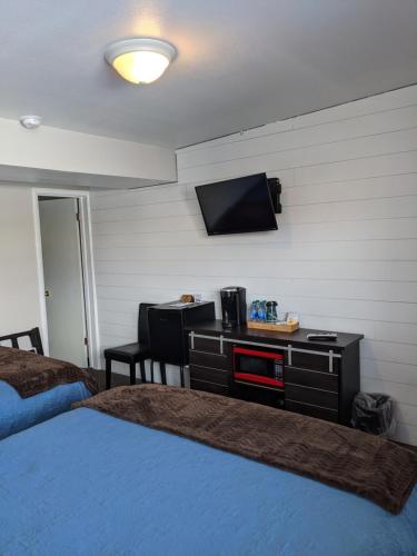 a bedroom with a bed and a tv on a wall at Lost Trail in Lava Hot Springs