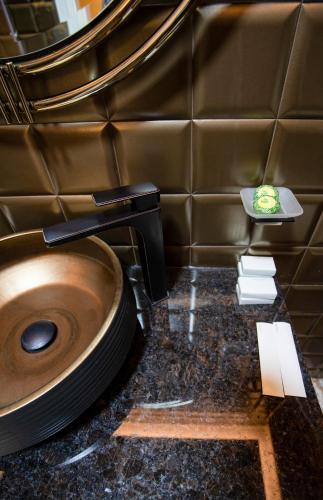 a bathroom with a toilet with a sink at Vila EKREM in Korçë