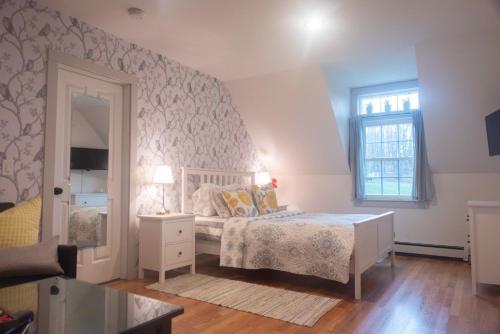 a bedroom with a bed and a window at Moonshadow B&B in Hammondsport