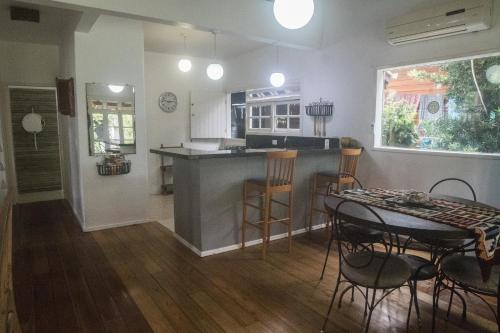 cocina y sala de estar con mesa y sillas en Casa de Praia Florianópolis, en Florianópolis