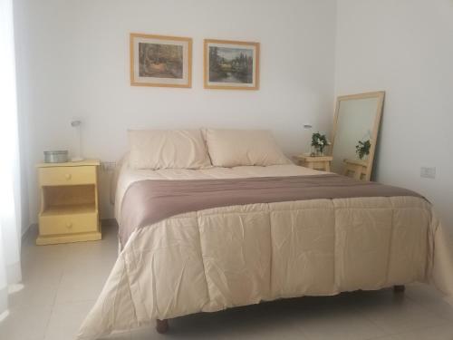1 dormitorio con 1 cama grande y 2 cuadros en la pared en Andoli 1 en Santa Rosa